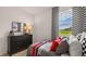 This bedroom features checkered curtains and racing-themed decor, creating a sporty and modern space at 130 Oakchase Park Ln, Hampton, GA 30228