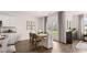 Open dining area with natural light, neutral decor, and seamless flow into the kitchen at 130 Oakchase Park Ln, Hampton, GA 30228