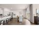 Bright dining area featuring a large window, white cabinetry, stainless appliances, and stylish decor at 130 Oakchase Park Ln, Hampton, GA 30228