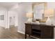 Inviting entryway with dark wood flooring, a decorative mirror, and a stylish sideboard with lamps at 130 Oakchase Park Ln, Hampton, GA 30228