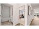 Hallway view of a modern home showing the bathroom and bedroom entrance plus living room in the background at 130 Oakchase Park Ln, Hampton, GA 30228