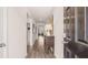 View down the hallway showing an entryway table lamp with hardwood floors and neutral gray wall paint at 130 Oakchase Park Ln, Hampton, GA 30228
