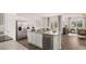 Bright kitchen featuring stainless steel appliances, granite countertops, and an adjacent dining area at 130 Oakchase Park Ln, Hampton, GA 30228