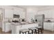 Stylish kitchen with white cabinets, granite countertops, stainless steel appliances and island with seating at 130 Oakchase Park Ln, Hampton, GA 30228