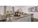 Modern kitchen island with granite countertops, stainless steel sink, and a dining area nearby at 130 Oakchase Park Ln, Hampton, GA 30228