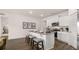 Kitchen island with bar stool seating, granite countertops, and open view to other living spaces at 130 Oakchase Park Ln, Hampton, GA 30228