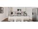 Kitchen with white cabinets, granite countertops, stainless steel appliances and island with barstool seating at 130 Oakchase Park Ln, Hampton, GA 30228