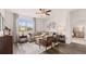 Cozy living room featuring a large window, comfortable seating, stylish decor, and modern ceiling fan at 130 Oakchase Park Ln, Hampton, GA 30228