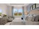 Comfortable main bedroom with scenic views from the large window, plus stylish furnishings at 130 Oakchase Park Ln, Hampton, GA 30228