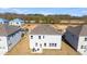Aerial view of the back of the house and the backyard and some surrounding houses at 93 Sheryl Way, Loganville, GA 30052