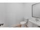 Compact half-bathroom featuring a pedestal sink and a modern toilet, designed for convenience and efficiency at 93 Sheryl Way, Loganville, GA 30052