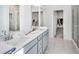 Stylish bathroom featuring double sinks, modern fixtures, and a glass-enclosed shower at 93 Sheryl Way, Loganville, GA 30052
