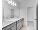 Well-lit bathroom features double sinks, a large mirror, and clean lines for a modern look at 93 Sheryl Way, Loganville, GA 30052