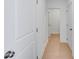 Bright hallway with hardwood floors and white doors, creating a clean and modern transition between rooms at 93 Sheryl Way, Loganville, GA 30052