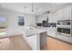 Modern kitchen with stainless steel appliances, quartz countertops, and stylish backsplash at 93 Sheryl Way, Loganville, GA 30052
