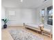 Bright living room with light wood floors, bench seating, neutral rug and lots of natural light at 93 Sheryl Way, Loganville, GA 30052