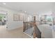 Upstairs hallway with wood railing and neutral wall colors at 6098 Marigold Way, Atlanta, GA 30349