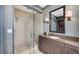 Elegant bathroom featuring a glass shower, granite countertop, and decorative wall mirror at 88 W Paces Ferry Nw Rd # 1740, Atlanta, GA 30305