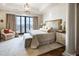This luxurious bedroom features a sitting area, balcony access, and refined decor at 88 W Paces Ferry Nw Rd # 1740, Atlanta, GA 30305