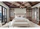 The primary bedroom features balcony access, custom built-in cabinetry, and neutral décor at 88 W Paces Ferry Nw Rd # 1740, Atlanta, GA 30305