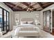 The primary bedroom features balcony access, custom built-in cabinetry, and neutral décor at 88 W Paces Ferry Nw Rd # 1740, Atlanta, GA 30305