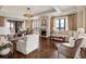 Bright living room featuring hardwood floors, a fireplace, windows with a view, and comfortable seating at 88 W Paces Ferry Nw Rd # 1740, Atlanta, GA 30305