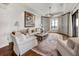 Cozy living room with hardwood floors, a large painting, comfortable seating, and a decorative rug at 88 W Paces Ferry Nw Rd # 1740, Atlanta, GA 30305