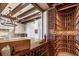 The wine cellar features wooden wine racks, a countertop, wooden accents, and a glass wall to the kitchen at 88 W Paces Ferry Nw Rd # 1740, Atlanta, GA 30305