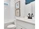 Well-lit bathroom features a tub, toilet, and modern vanity with artwork at 151 Sunshower Rdg, Canton, GA 30114
