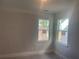 Bright unfinished bedroom with neutral walls, white trim, and two windows offering natural light, creating a serene space at 151 Sunshower Rdg, Canton, GA 30114