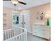 Stylish Bedroom boasts a comfortable crib and white dresser with gold accents at 151 Sunshower Rdg, Canton, GA 30114