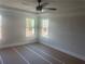 Bedroom with a modern ceiling fan and two large windows offering ample natural light at 151 Sunshower Rdg, Canton, GA 30114