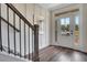 Bright entryway with hardwood floors, staircase, and a white front door offering a view outside at 151 Sunshower Rdg, Canton, GA 30114