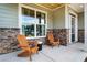 Inviting front porch with stone accents, two Adirondack chairs, and a view into the neighborhood at 151 Sunshower Rdg, Canton, GA 30114