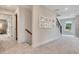 Inviting hallway with a staircase, open doorway, and neutral-toned walls at 151 Sunshower Rdg, Canton, GA 30114
