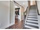 Modern hallway with hardwood floors, barn door, staircase, and stylish interior design elements at 151 Sunshower Rdg, Canton, GA 30114