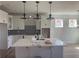 Bright kitchen with white cabinets, granite countertops, stainless steel appliances, and modern globe pendant lights at 151 Sunshower Rdg, Canton, GA 30114