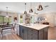 Beautiful kitchen with an island, stainless steel appliances, and pendant lighting open to the dining area at 151 Sunshower Rdg, Canton, GA 30114