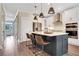 Spacious kitchen featuring a large island with seating, stainless steel appliances, and white cabinetry at 151 Sunshower Rdg, Canton, GA 30114