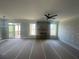 Spacious living room with a stone fireplace and sliding doors to an outdoor deck at 151 Sunshower Rdg, Canton, GA 30114