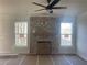 Unfinished living room featuring a stone fireplace, and two windows providing ample natural light at 151 Sunshower Rdg, Canton, GA 30114
