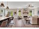 Bright open-concept living space featuring a stone fireplace, hardwood floors, and large windows for natural light at 151 Sunshower Rdg, Canton, GA 30114