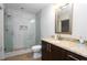 Contemporary bathroom featuring a glass-enclosed shower and granite countertop vanity at 1080 Peachtree Ne St # 1408, Atlanta, GA 30309