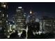 Night view of the city skyline, highlighting modern buildings and illuminated streets below at 1080 Peachtree Ne St # 1408, Atlanta, GA 30309