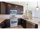 Modern kitchen with stainless steel appliances, granite countertops, and stylish lighting fixtures at 1080 Peachtree Ne St # 1408, Atlanta, GA 30309