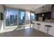 Open living space with balcony access and city views with bar seating and pendant lighting at 1080 Peachtree Ne St # 1408, Atlanta, GA 30309