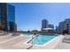 Luxury rooftop swimming pool with city views, lounge chairs, and umbrellas for relaxing in style at 1080 Peachtree Ne St # 1408, Atlanta, GA 30309