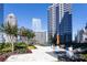 Beautifully landscaped rooftop terrace with comfortable seating, greenery, and city skyline views at 1080 Peachtree Ne St # 1408, Atlanta, GA 30309