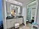 Bright bathroom features a double sink vanity and full shower and tub enclosure at 4359 Idlewood Ln, Tucker, GA 30084