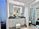 Bright bathroom features a double sink vanity and full shower and tub enclosure at 4359 Idlewood Ln, Tucker, GA 30084